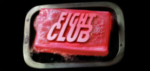 A depressed man (Edward Norton) suffering from insomnia meets a strange soap salesman named Tyler Durden (Brad Pitt) and soon finds himself living in his squalid house after his perfect apartment is destroyed. The two bored men form an underground club with strict rules and fight other men who are fed up with their mundane lives. Their perfect partnership frays when Marla (Helena Bonham Carter), a fellow support group crasher, attracts Tyler's attention.